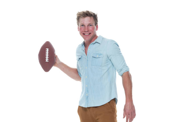 istock Casually dressed man holding a football 1151711796