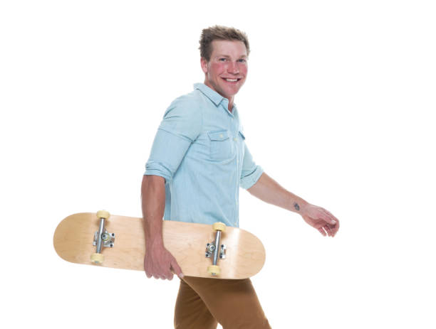istock Casual well dressed man walking with a skateboard 1151713358