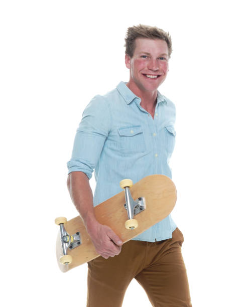istock Casual well dressed man walking with a skateboard 1151713364