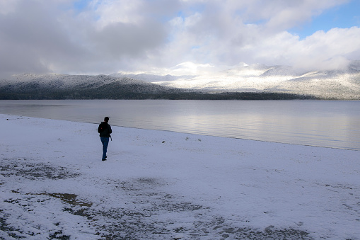 when sunrise a man walking alone at Te anau Lake, winter season
