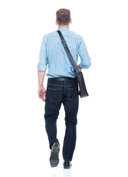 istock Rear view of man walking with a shoulder bag 1151716759
