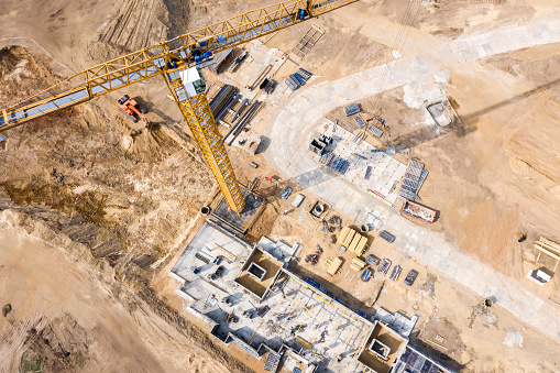 construction site with crane and apartment building under construction. eye bird view