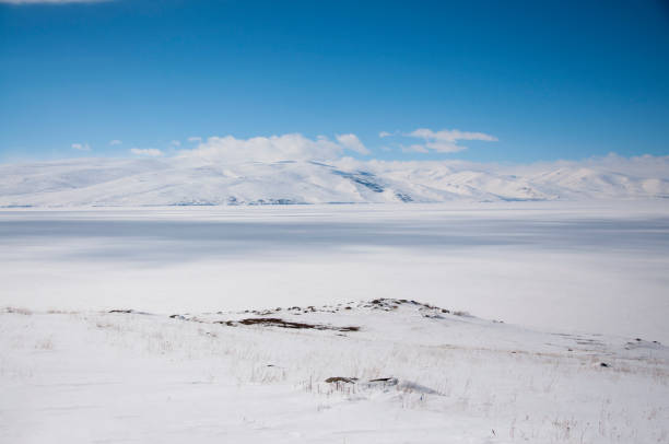 istock Icy Lake and mountains with clouds 1151729076