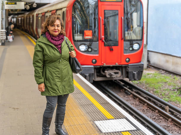istock Mature Hispanic woman smiling on subway platform 1151729883