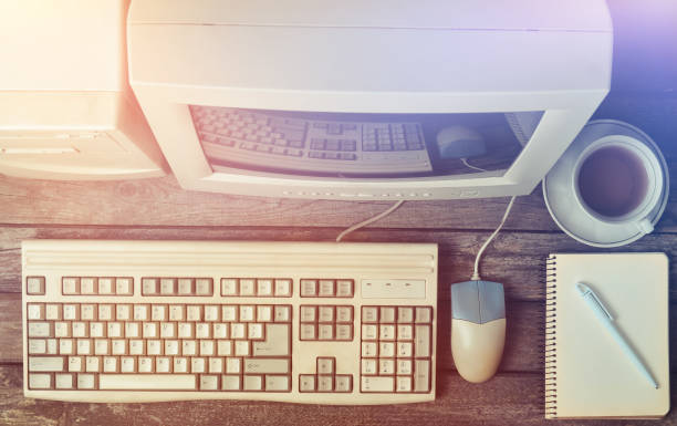 istock Retro stationary computer on a rustic wooden table, vintage workspace, top view, flat lay 1151730163