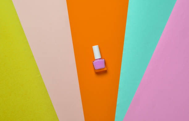istock Nail polish bottle on a colored paper background, minimalism, top view 1151730173