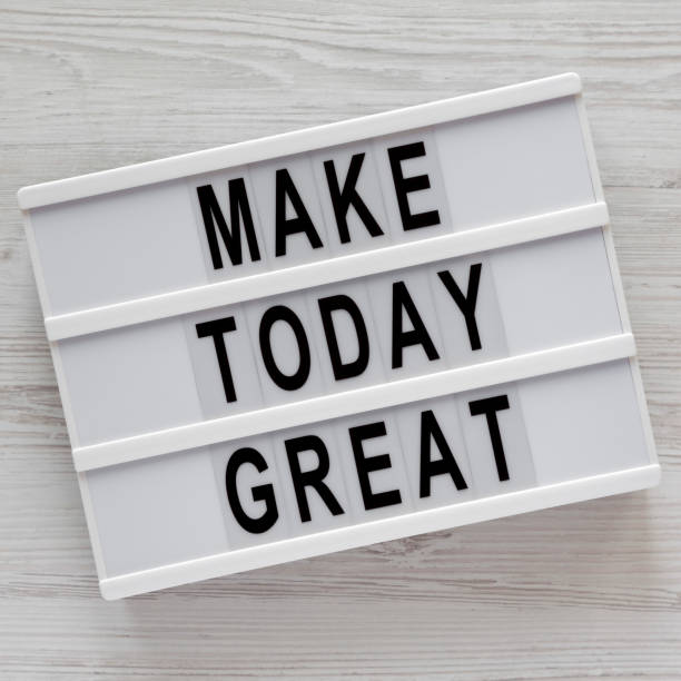 istock Modern board with 'Make today great' words on a white wooden table, top view. Overhead, from above. Flat lay. 1151732126