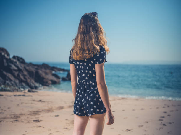 istock Beautiful young woman  on the beach 1151732818