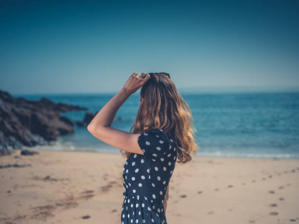 istock Beautiful young woman  on the beach 1151733089
