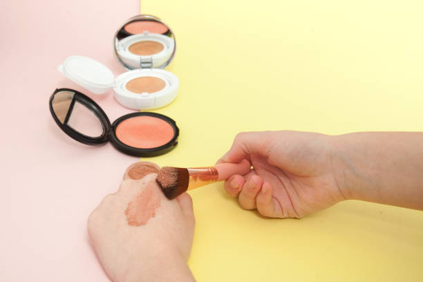 istock Make up products spilling on to a bright yellow and pink background with copy space 1151734474