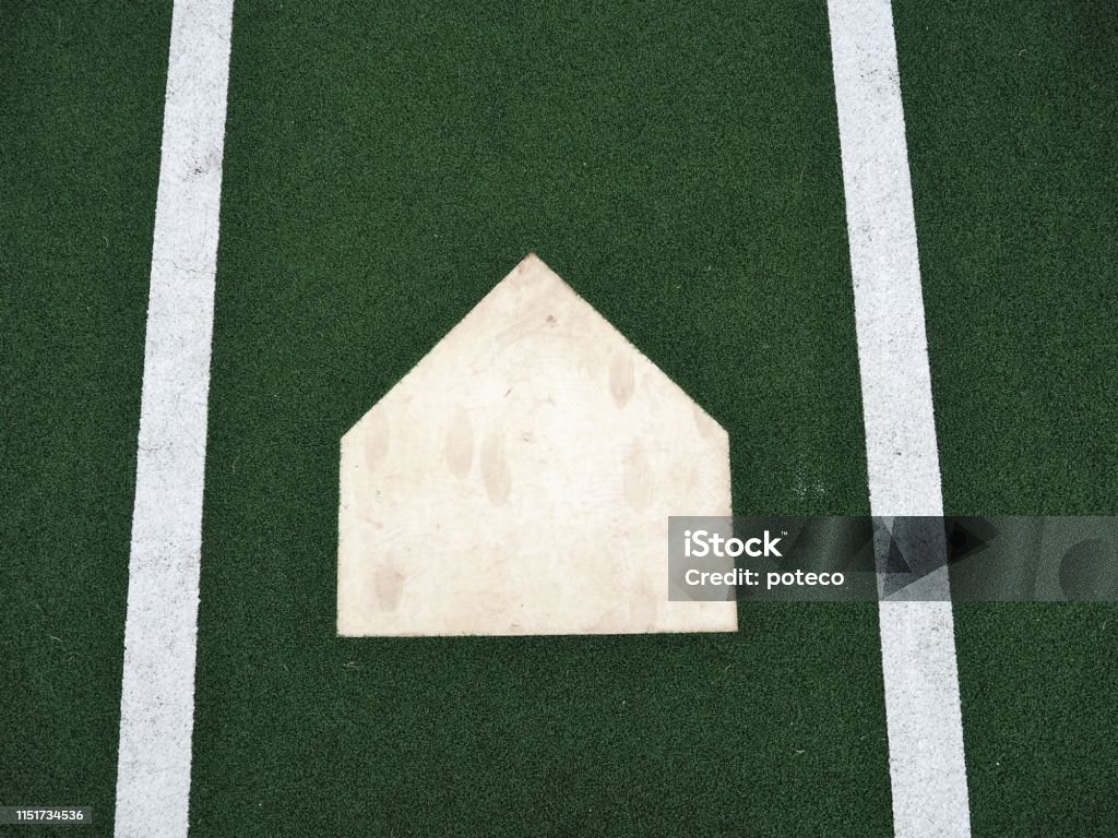 Baseball home plate on artificial lawn background High Angle View Stock Photo