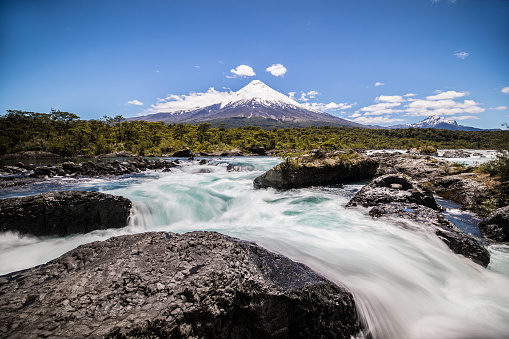 Waterfall in the foreground of the Osorno Volcano located in Puerto Montt within the Lake District in Chille