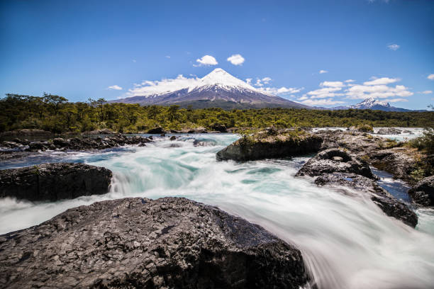 Osorno Volcano, Puerto Montt, Chille Waterfall in the foreground of the Osorno Volcano located in Puerto Montt within the Lake District in Chille andes mountains chile stock pictures, royalty-free photos & images