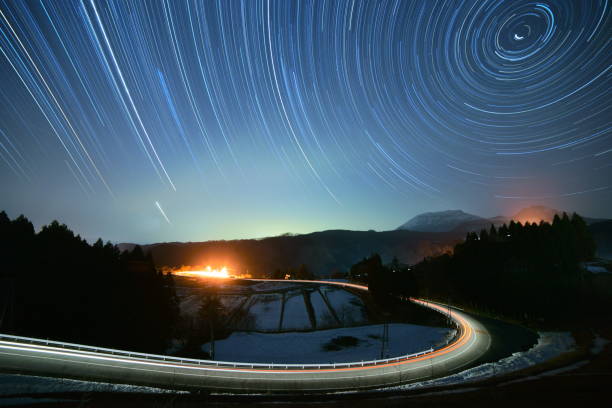 star trails and a car light trail in the southern area of mt. daisen - 2546 imagens e fotografias de stock