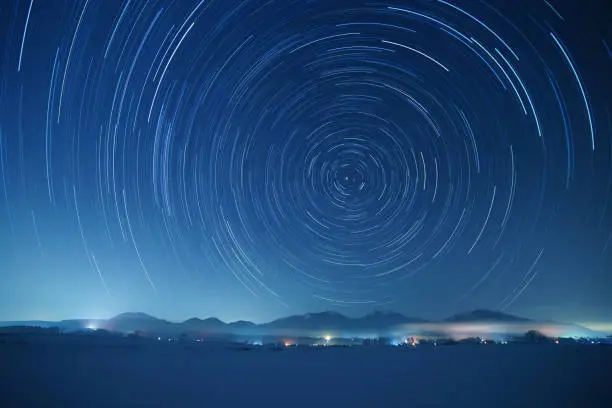 Star trails over Mt. Hiruzen and Mt. Daisen in winter. These mountains are famous sightseeing spots in Chugoku district, Japan.
