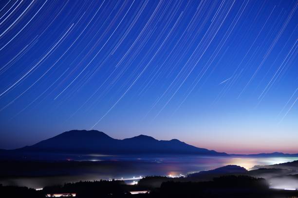 istock Star trails above Mt. Hiruzen from night to dawn 1151737618