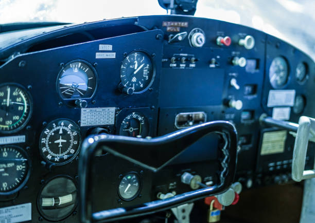 View from beyond the control panel of a cessna airplane with no roof or side windows in the frame to achieve an open canopy effect.  All text is generic warning notes and instrument readings. Clipping path for control panel embedded.