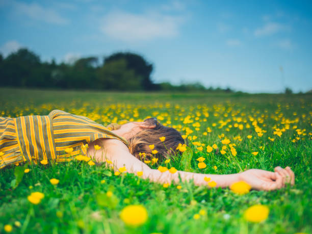 istock Young woman lying in meadow 1151742074
