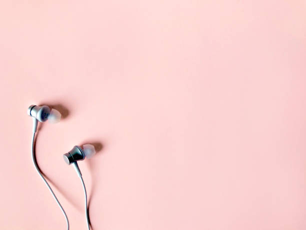 istock white ear phone on pastel pink color background summer 1151743830