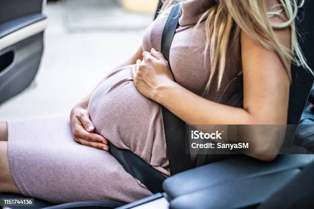 Pregnant Woman With Safety Seat Belt Stock Photo - Download Image Now - Pregnant, Car, Women