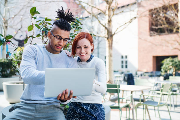 istock Young businesspeople with laptop in courtyard, start-up concept. 1151745108
