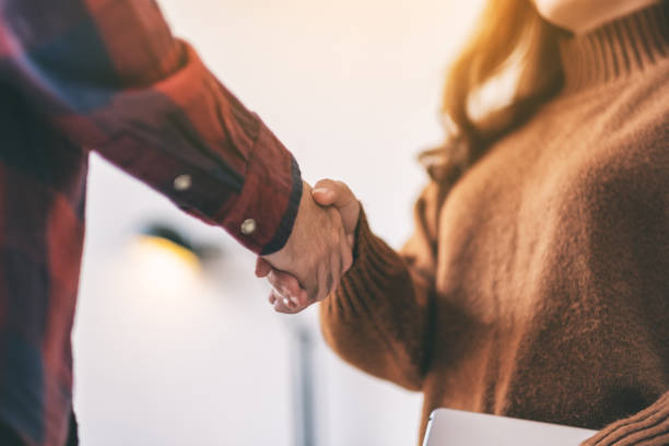 istock Closeup image of two people shaking hands 1151745264