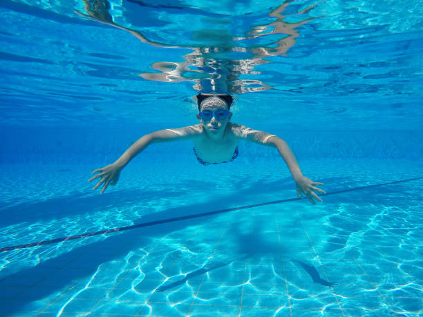 istock Child boy swimming pool water playing summer vacation fun 1151745316