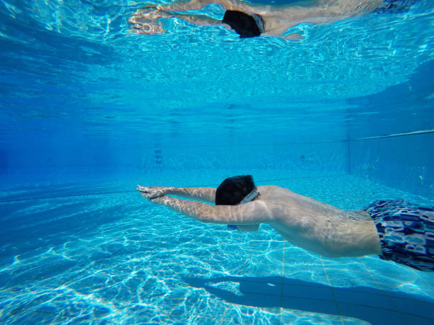 istock Child boy swimming pool water playing summer vacation fun 1151745377