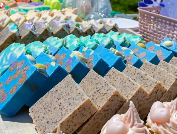 Photo of Beautiful colorful handmade soap. Soap manufacture Eco goods. Fair - an exhibition of folk craftsmen.