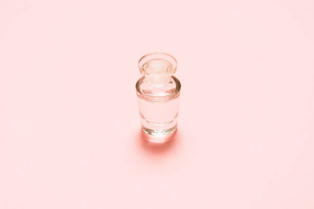 istock One fragrance bottle with liquid on pink background. Mock-up 1151745658