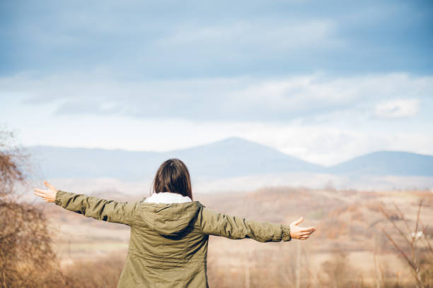 istock Woman spreading hands with joy in nature 1151746388