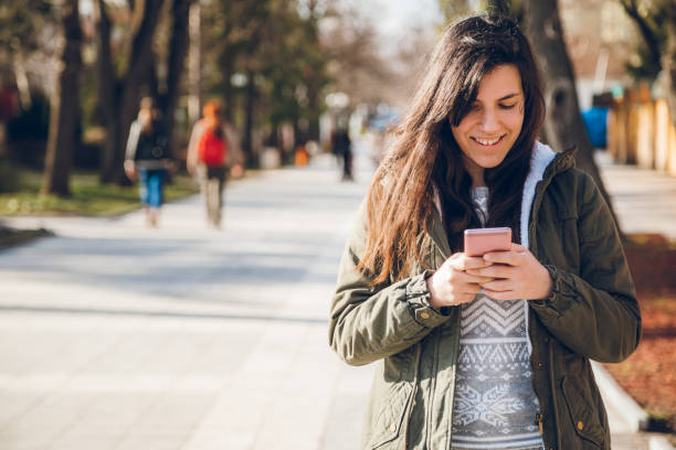 istock Young woman using phone in the street 1151746416