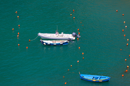 Moored boats in the marina, smooth water surface, background, Vernazza, Italy