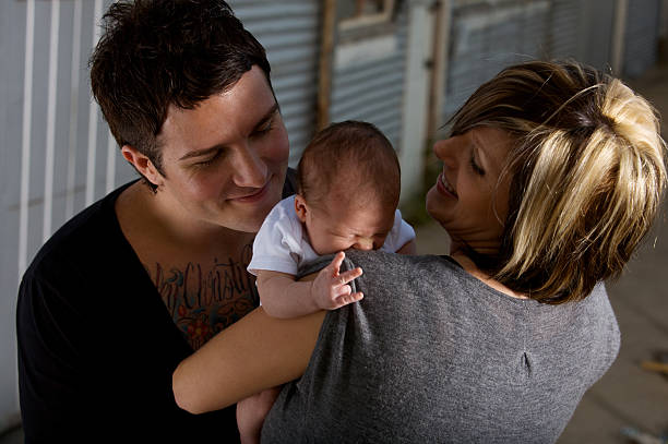young family on summer evening with two week old baby girl