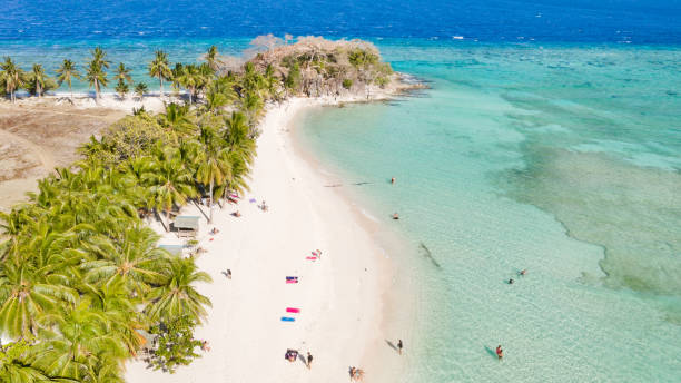 istock Lagoon with a white beach. Tourists relax on the beach 1151753282