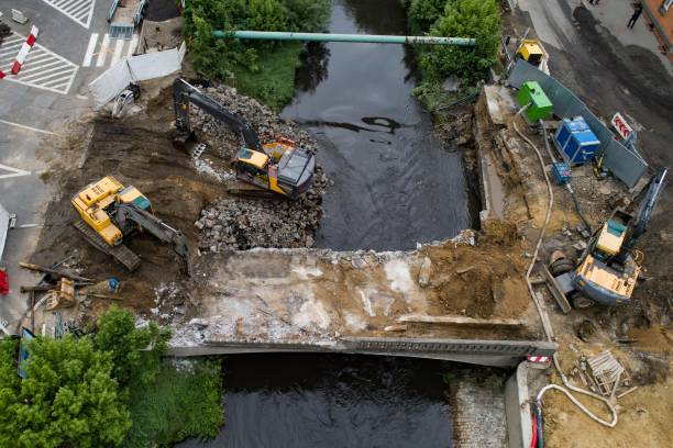istock Drone view on excavators demolishing a road bridge. 1151758441