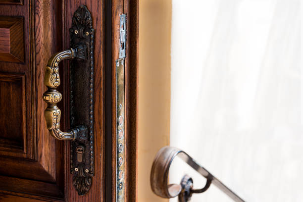 istock Open wooden door with antique bronze handle, railings and copy space. 1151763502