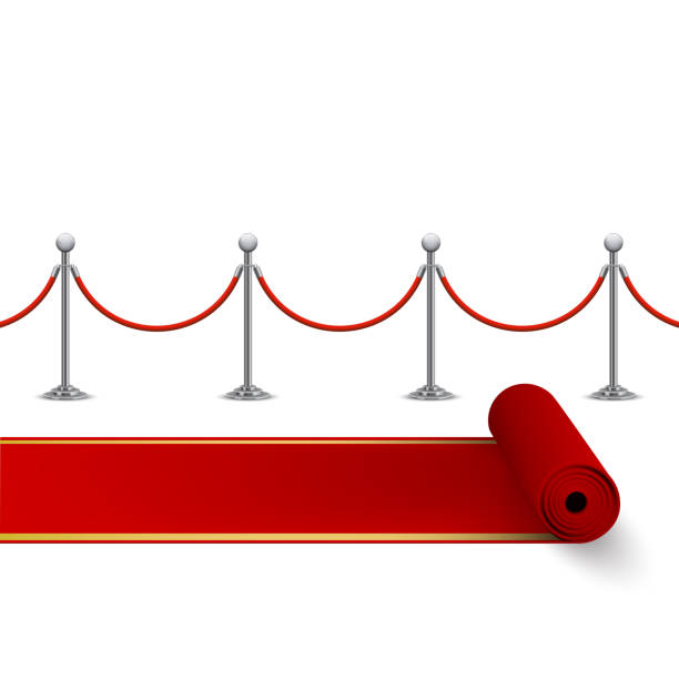 istock Rolled red carpet and fence with metal stanchions 1151764685