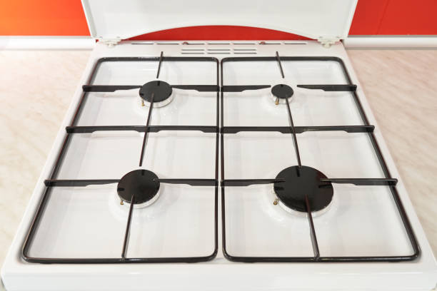 Classic white gas stove and four burners. Close-up