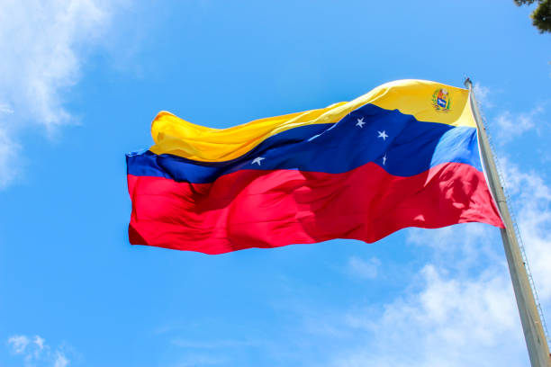 istock venezuela flag waving in the wind, blue sky cleared. 1151765286
