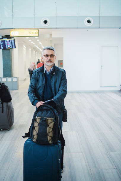 istock Man waiting for her flight in airport lounge 1151767267