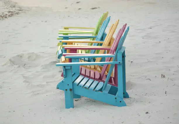 Pretty pastel colored adirondak chairs on a beach in Aruba.
