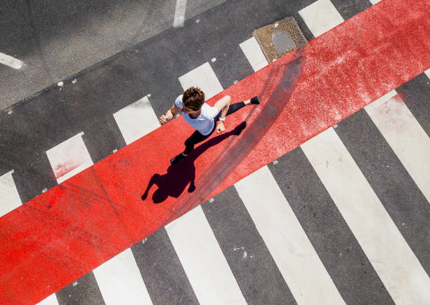 istock Woman Running Through a Zebra Crossing 1151767401