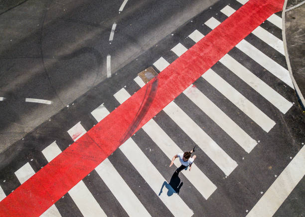 istock Woman Running Through a Zebra Crossing 1151767452