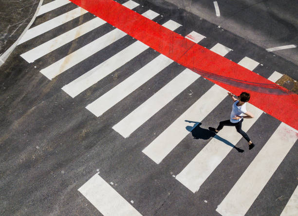 istock Woman Running Through a Zebra Crossing 1151767454