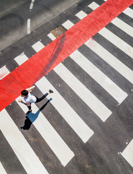 istock Woman Running Through a Zebra Crossing 1151767481