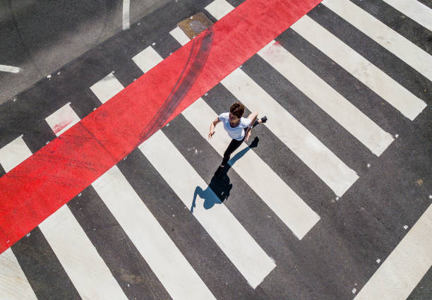 istock Woman Running Through a Zebra Crossing 1151767488