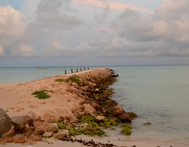 Aruba's rock jetty on a cloudy day.
