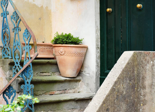Large terracotta vase decorate the entrance of this house near the doorsteps