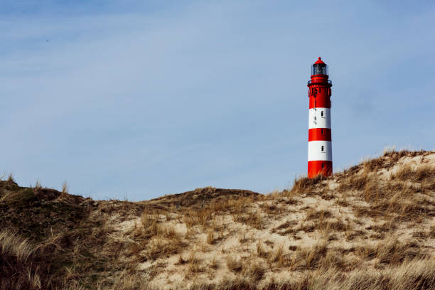 istock Amrum Red lighthouse on the hill in distance 1151768853